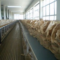 Volumes of coffee samples at the Nairobi Coffee Exchange. A silhouette of Mohsin Panju is on the left. Photo courtesy of Gordon Clark 2009.